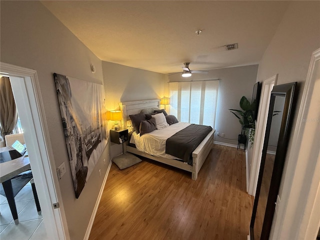 4333 Bayside Village Dr Unit 310, Tampa, FL 33615 - bedroom with light wood-type flooring, ceiling fan, and baseboards