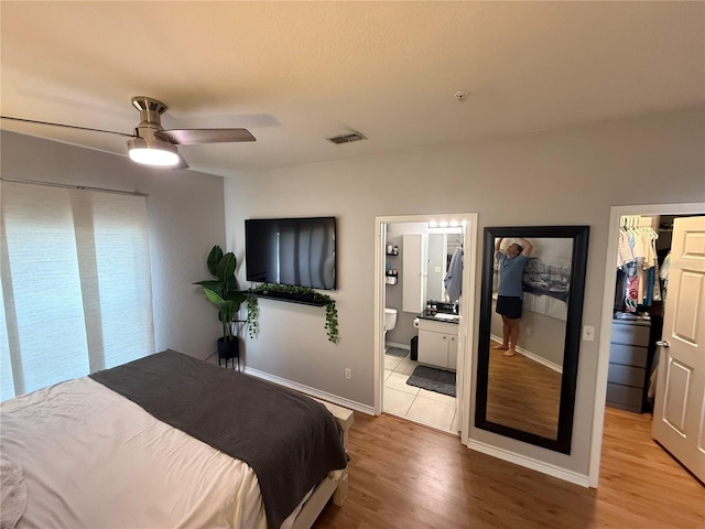 4333 Bayside Village Dr Unit 310, Tampa, FL 33615 - bedroom featuring wood finished floors, baseboards, ceiling fan, and ensuite bath