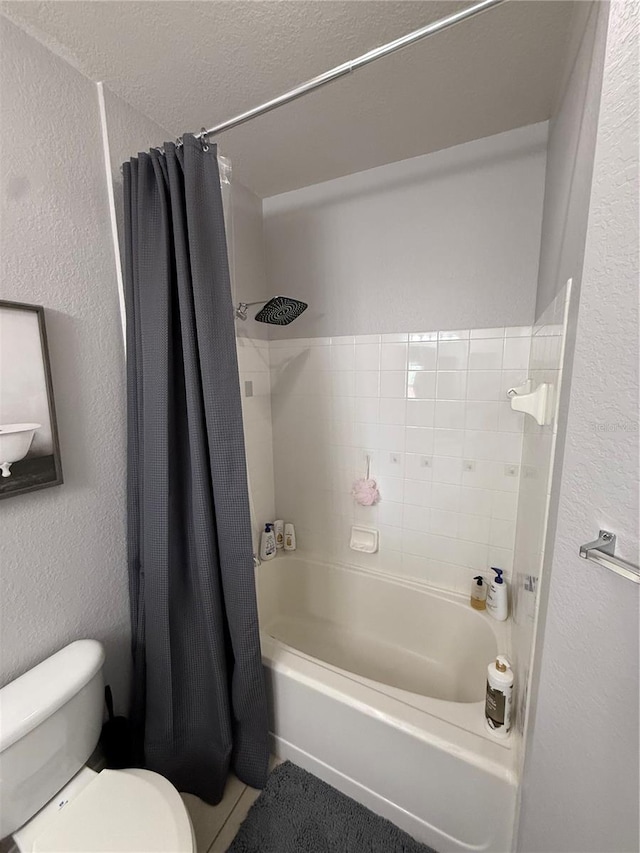 4333 Bayside Village Dr Unit 310, Tampa, FL 33615 - full bathroom with a textured wall, toilet, and shower / bathtub combination with curtain
