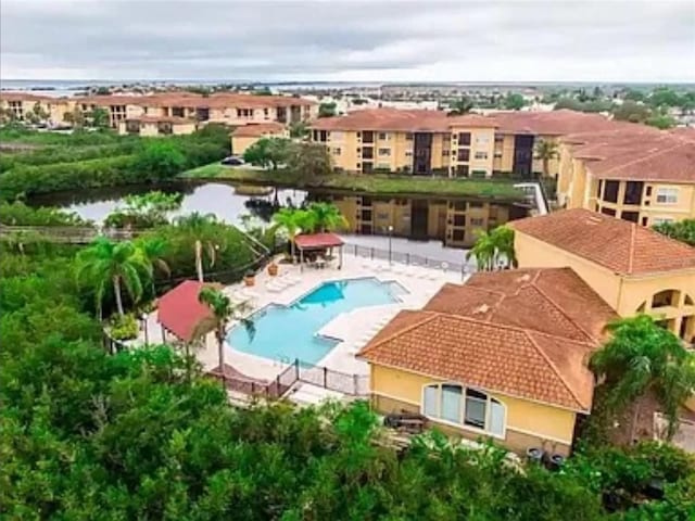 4333 Bayside Village Dr Unit 310, Tampa, FL 33615 - drone / aerial view of a pool area and a nearby body of water