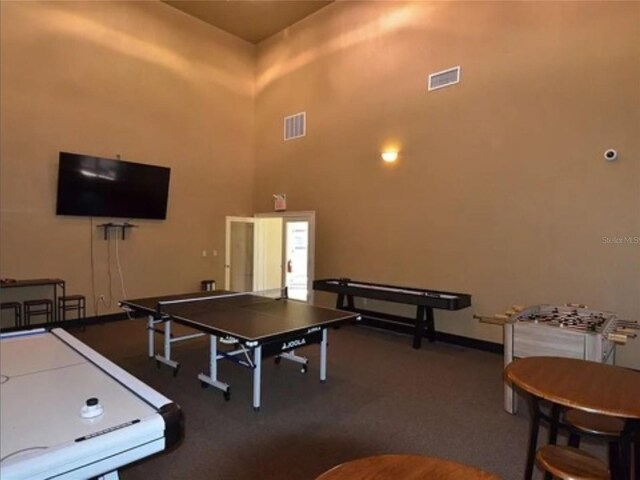 4333 Bayside Village Dr Unit 310, Tampa, FL 33615 - playroom featuring a towering ceiling, carpet floors, and baseboards