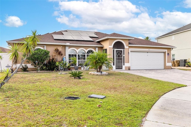 5113 Sage Way, Kissimmee, FL 34758 - view of front facade with an attached garage, stucco siding, and solar panels