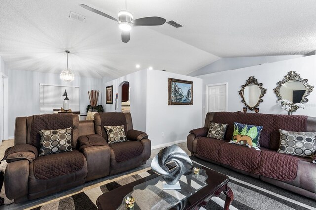 5113 Sage Way, Kissimmee, FL 34758 - carpeted living room featuring arched walkways, lofted ceiling, a ceiling fan, and baseboards