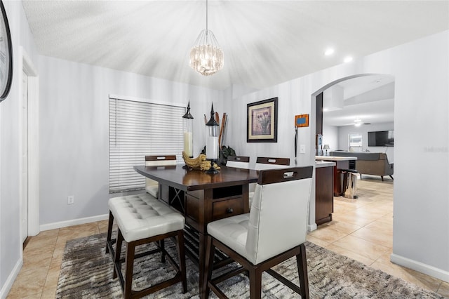5113 Sage Way, Kissimmee, FL 34758 - dining area with arched walkways, a chandelier, baseboards, and light tile patterned flooring