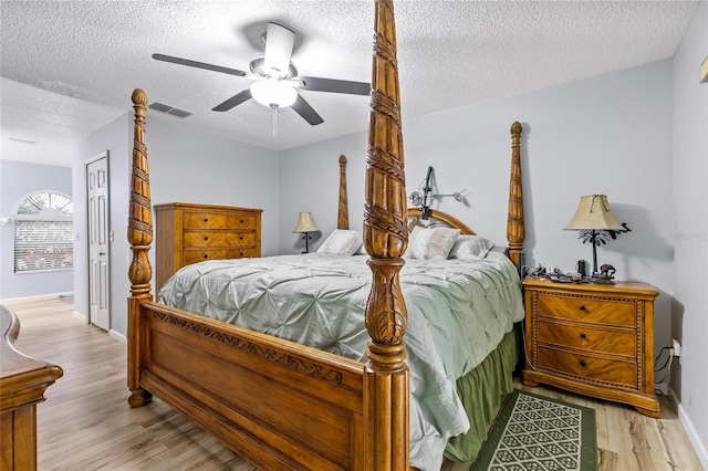 5113 Sage Way, Kissimmee, FL 34758 - bedroom featuring a textured ceiling, wood finished floors, ceiling fan, and baseboards