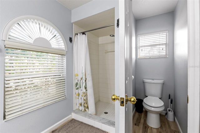 5113 Sage Way, Kissimmee, FL 34758 - bathroom featuring a shower stall, baseboards, toilet, and wood finished floors
