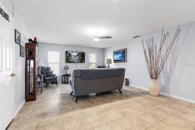 5113 Sage Way, Kissimmee, FL 34758 - living area with a textured ceiling, a ceiling fan, light tile patterned floors, and baseboards