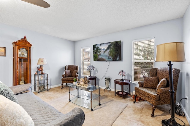 5113 Sage Way, Kissimmee, FL 34758 - living area featuring plenty of natural light, a textured ceiling, tile patterned flooring, and a ceiling fan