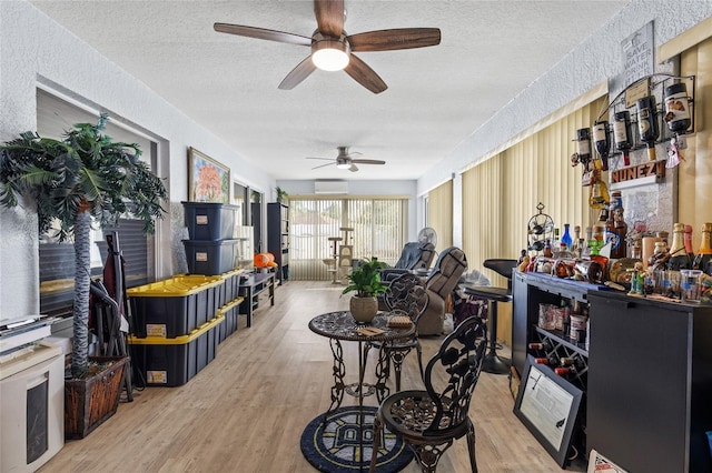 5113 Sage Way, Kissimmee, FL 34758 - sunroom / solarium featuring a textured ceiling, wood finished floors, a wall mounted air conditioner, and a textured wall