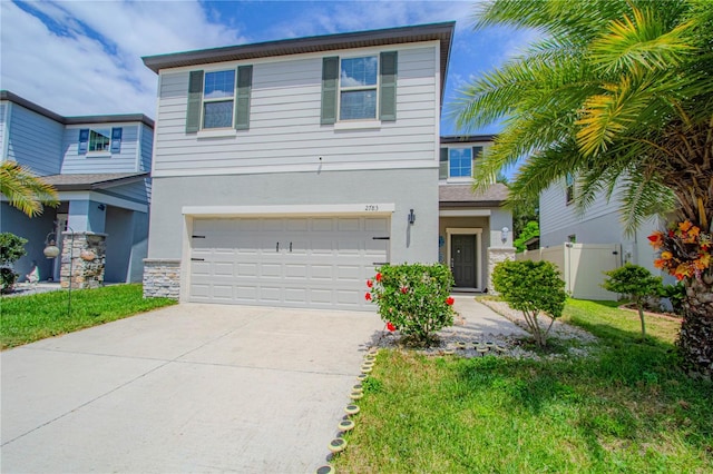 view of front of house featuring driveway, a garage, fence, a front lawn, and stucco siding