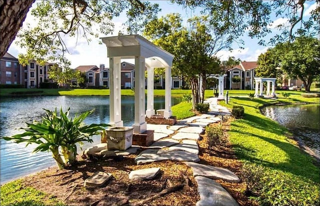 exterior space with a water view and a yard
