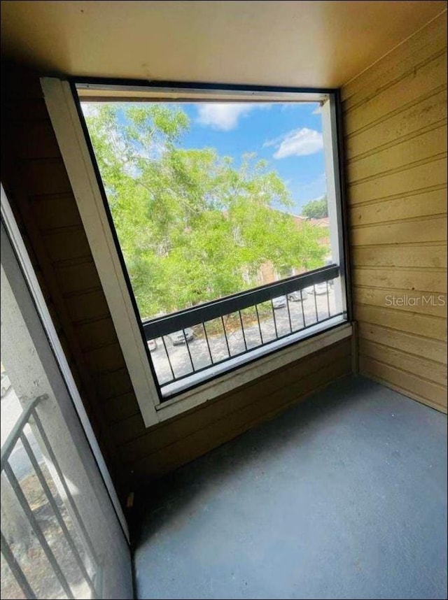 details featuring concrete flooring and wooden walls