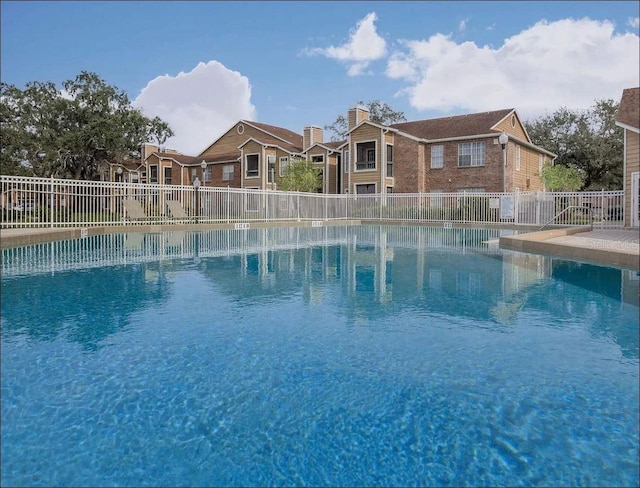 community pool featuring fence