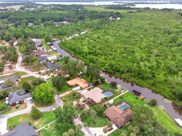 birds eye view of property with a water view, a forest view, and a residential view
