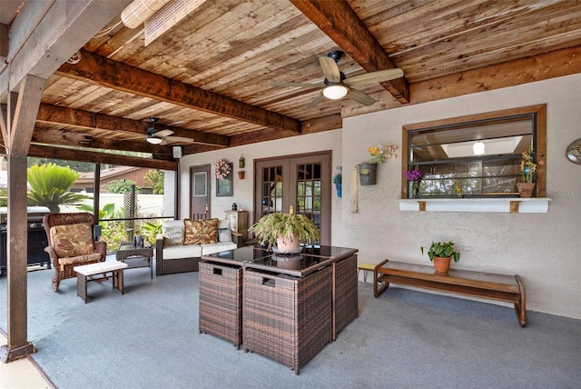 office space featuring carpet flooring, wood ceiling, and a ceiling fan