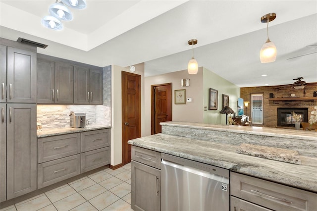 kitchen featuring hanging light fixtures, light tile patterned floors, visible vents, backsplash, and dishwasher