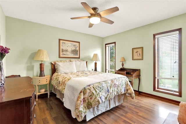 bedroom featuring wood finished floors, baseboards, and ceiling fan