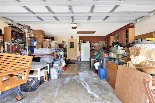 garage with freestanding refrigerator and a garage door opener
