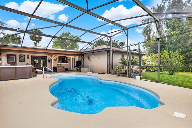 pool with a patio area, glass enclosure, and french doors