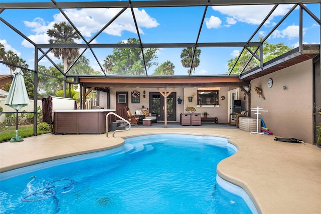 pool featuring a patio area, outdoor lounge area, and glass enclosure