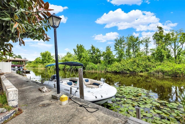 view of dock with a water view and a gazebo