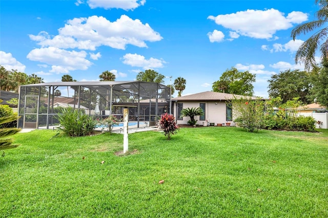 back of property featuring a yard, glass enclosure, and an outdoor pool