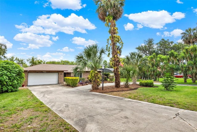 view of front of home with a front lawn, brick siding, driveway, and a garage