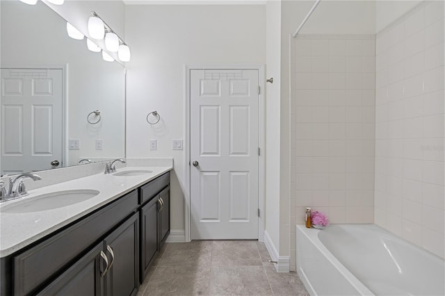 bathroom with tile patterned floors, double vanity, tub / shower combination, and a sink