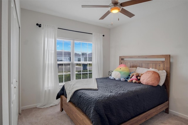 bedroom with baseboards, carpet flooring, and a ceiling fan