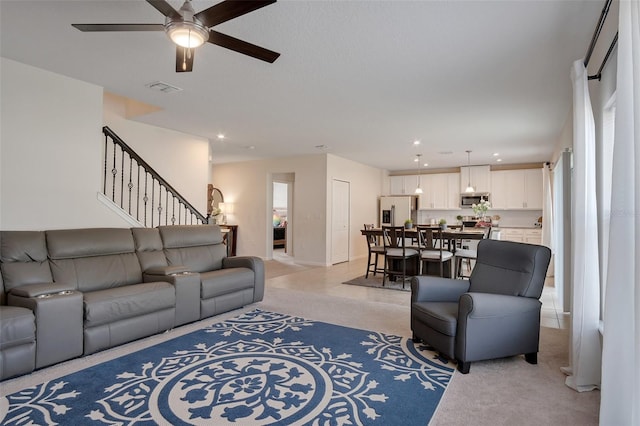 living area with stairway, ceiling fan, recessed lighting, and visible vents