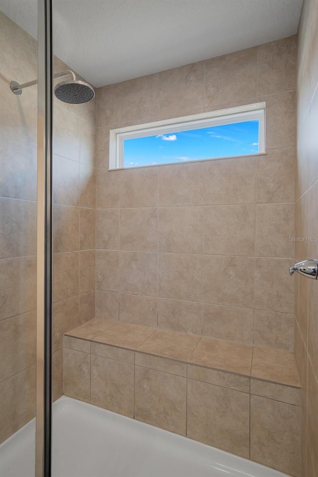 bathroom featuring a tile shower