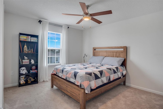 bedroom featuring baseboards, ceiling fan, and carpet flooring
