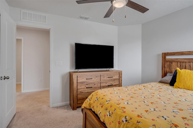 bedroom with visible vents, baseboards, ceiling fan, and light colored carpet