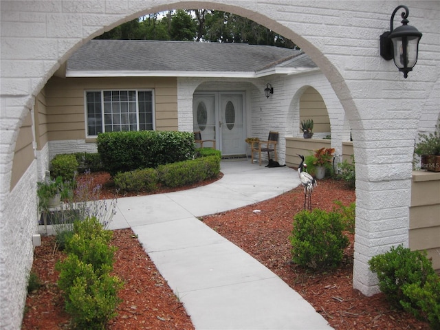 7026 Lenape Cir, New Port Richey, FL 34653 - doorway to property featuring a shingled roof