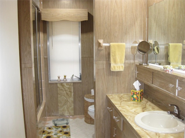 7026 Lenape Cir, New Port Richey, FL 34653 - bathroom with vanity and bath / shower combo with glass door