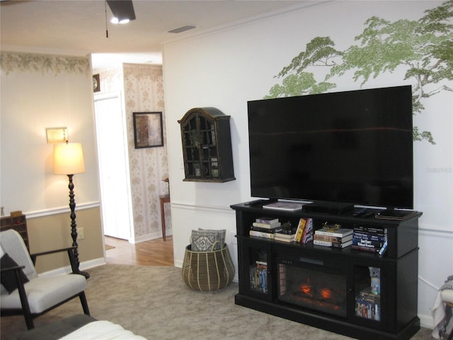 7026 Lenape Cir, New Port Richey, FL 34653 - living room featuring carpet, wallpapered walls, and crown molding