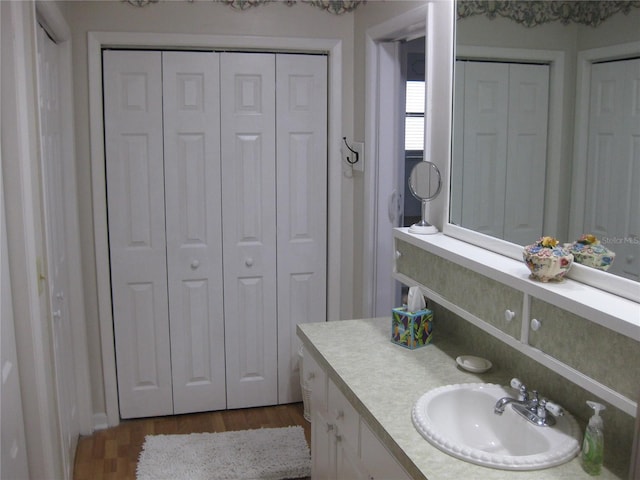 7026 Lenape Cir, New Port Richey, FL 34653 - bathroom with a closet, vanity, and wood finished floors