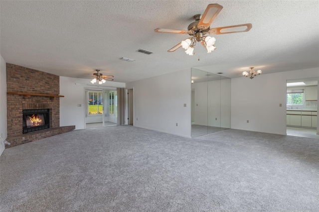 10980 SW 62nd Ave, Ocala, FL 34476 - unfurnished living room featuring visible vents, a ceiling fan, a textured ceiling, and a fireplace