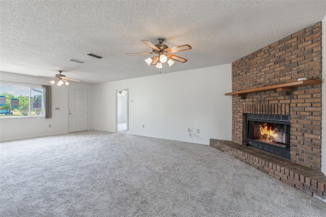 10980 SW 62nd Ave, Ocala, FL 34476 - unfurnished living room with a fireplace, a textured ceiling, carpet, a ceiling fan, and visible vents