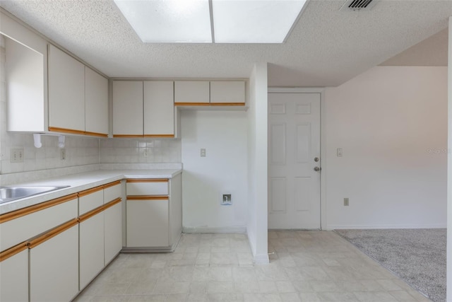 10980 SW 62nd Ave, Ocala, FL 34476 - kitchen with light countertops, tasteful backsplash, a textured ceiling, and visible vents