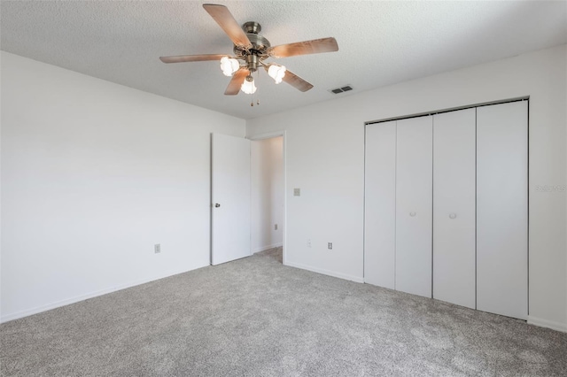 10980 SW 62nd Ave, Ocala, FL 34476 - unfurnished bedroom featuring a closet, a ceiling fan, visible vents, a textured ceiling, and carpet flooring