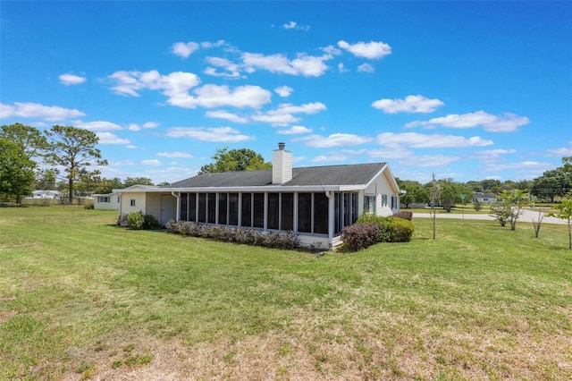 10980 SW 62nd Ave, Ocala, FL 34476 - back of property featuring a sunroom, a yard, and a chimney