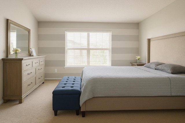 bedroom with baseboards and light carpet