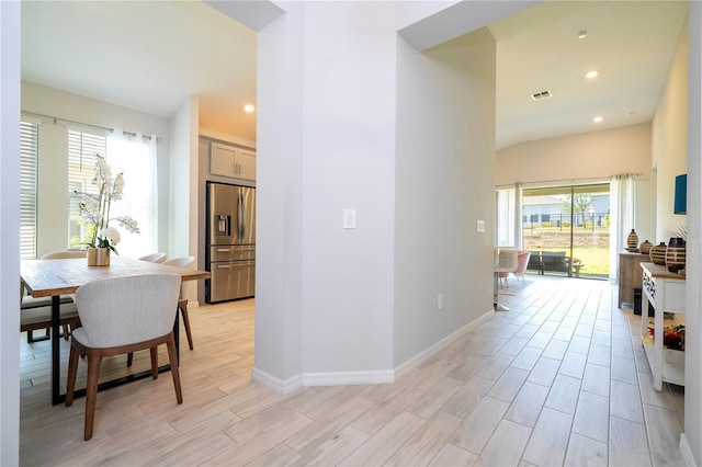 hallway featuring recessed lighting, baseboards, visible vents, and light wood-style floors