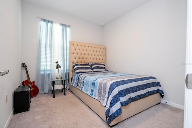 bedroom featuring baseboards and carpet flooring