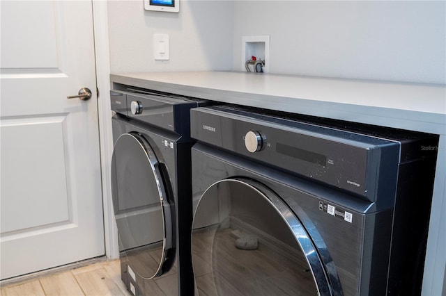 washroom featuring laundry area and washer and clothes dryer