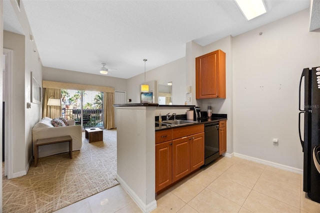 7395 Universal Blvd Unit 203, Orlando, FL 32819 - kitchen with a sink, brown cabinets, a peninsula, black appliances, and dark countertops