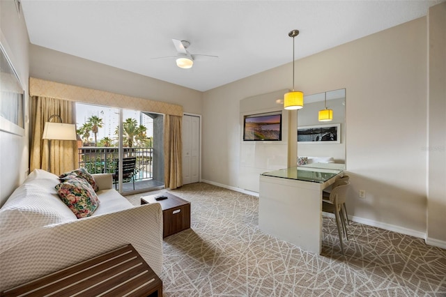 7395 Universal Blvd Unit 203, Orlando, FL 32819 - living area with ceiling fan, baseboards, and carpet floors