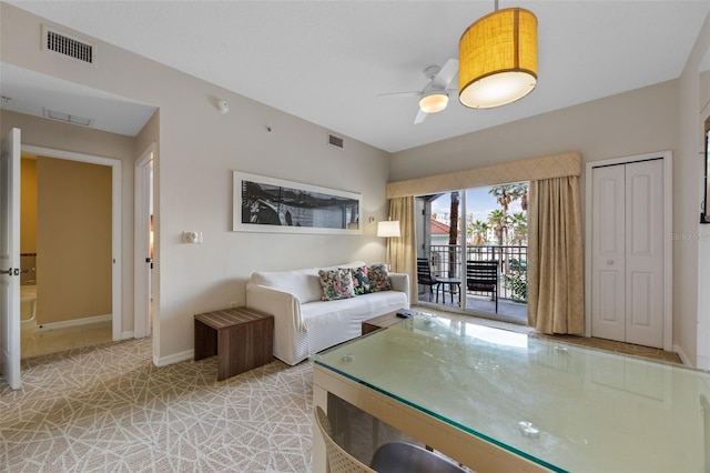 7395 Universal Blvd Unit 203, Orlando, FL 32819 - living room with a ceiling fan, baseboards, and visible vents
