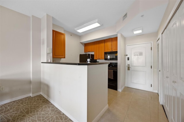 7395 Universal Blvd Unit 203, Orlando, FL 32819 - kitchen featuring range, fridge, visible vents, black microwave, and dark countertops